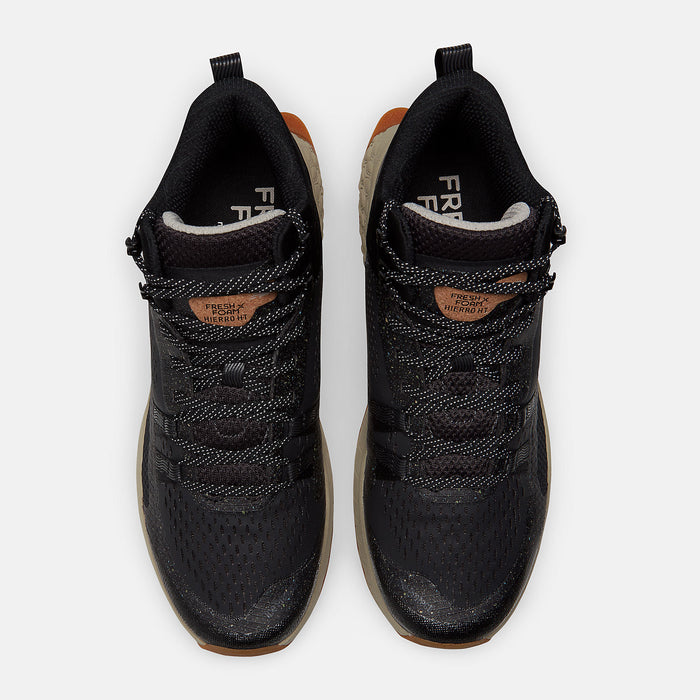 New Balance Foam X Hierro Mid GTX trail shoes in black with perforated mesh upper, lace system, and orange accents, top view.