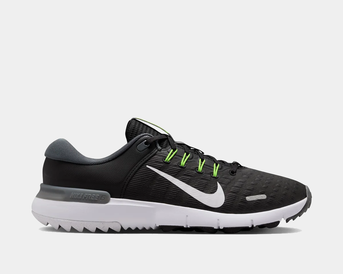 Nike Free Golf Next Nature golf shoes in black with mesh upper, white sole, neon green lace accents, and side Swoosh logo, side view.