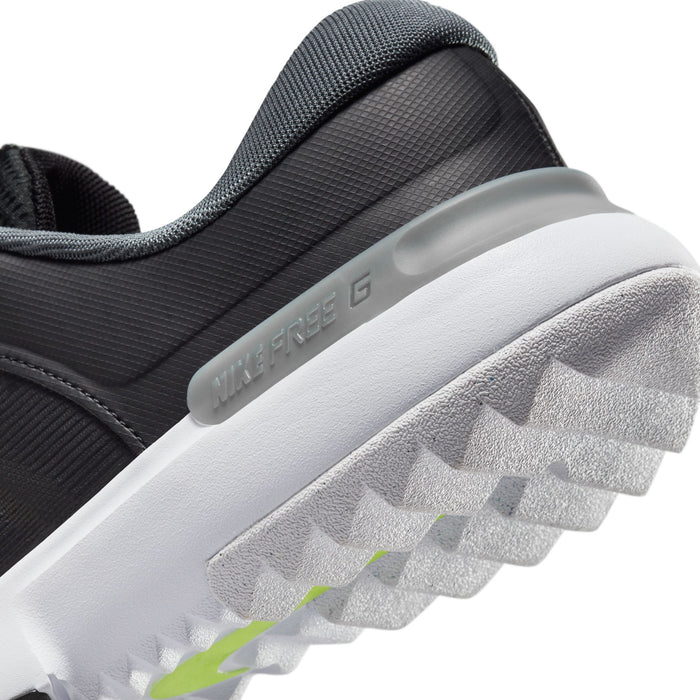 Nike Free Golf Next Nature golf shoes, black and gray upper with textured white and gray outsole, close-up side view.