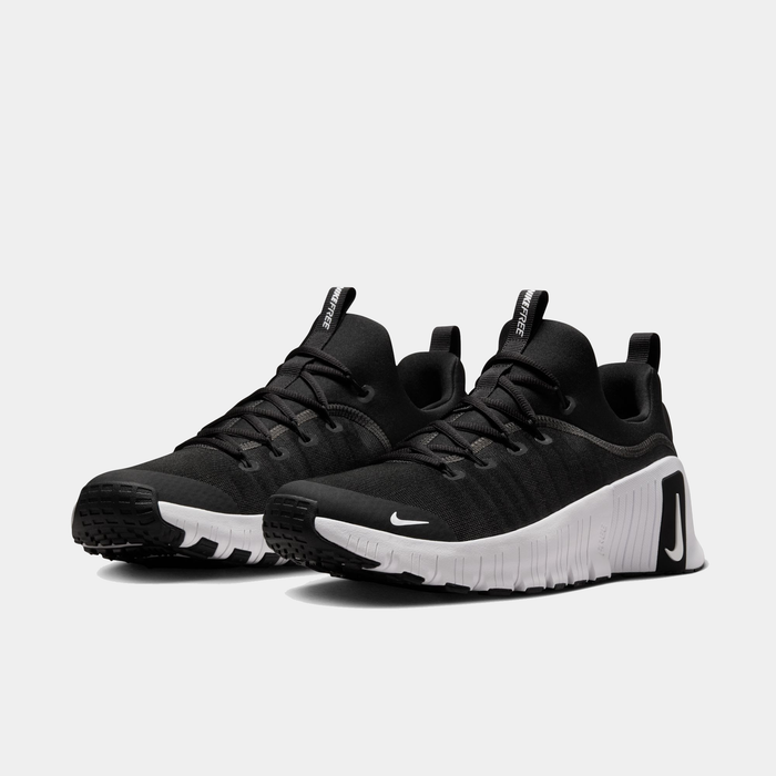 Nike Free Metcon 6 TB training shoes in black with a white midsole and flexible outsole, angled front view.