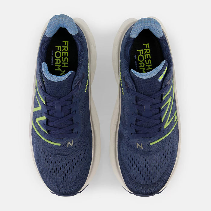 New Balance Fresh Foam More v4 running shoes in navy blue with breathable mesh upper and neon green accents, top view.