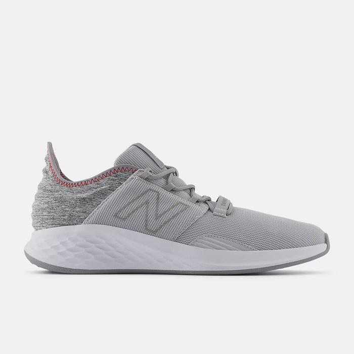 New Balance Golf Fresh Foam ROAV Golf shoes, side view in gray with knit upper, cushioned midsole, and red stitch accents.