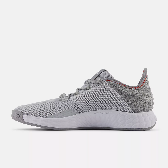 New Balance Golf Fresh Foam ROAV Golf shoes in light gray with a breathable mesh upper, textured heel design, and cushioned sole, side view.