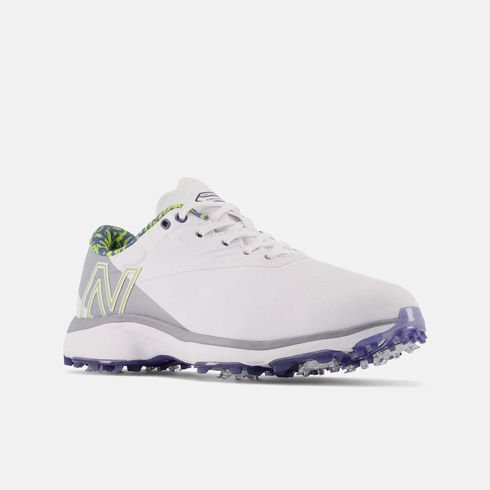 New Balance Golf Fresh Foam X Defender golf shoes in white with gray accents and purple spiked outsole, side/front view.