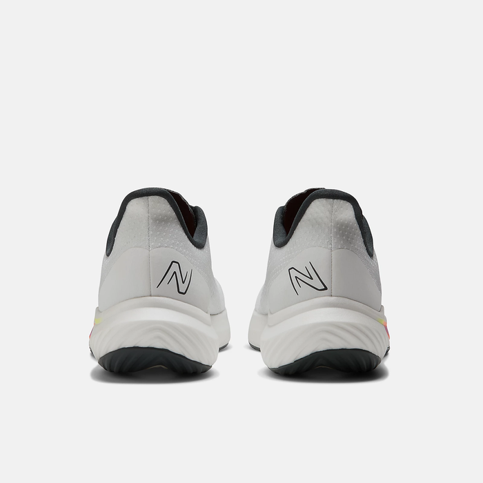 New Balance FuelCell Rebel v3 running shoes in white with black accents and logo detailing, back view showing heel design.