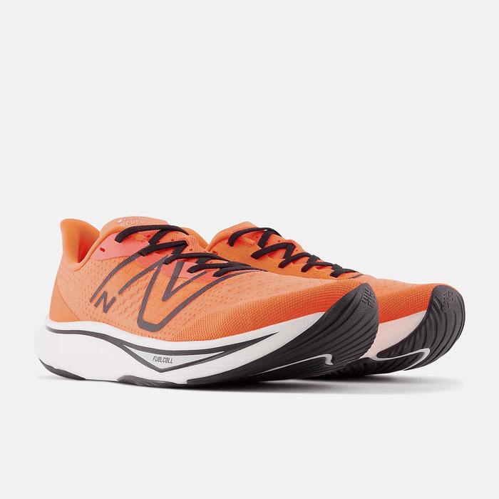 New Balance FuelCell Rebel v3 running shoes in vibrant orange with black accents, mesh upper, and cushioned white midsole, angled front-side view.