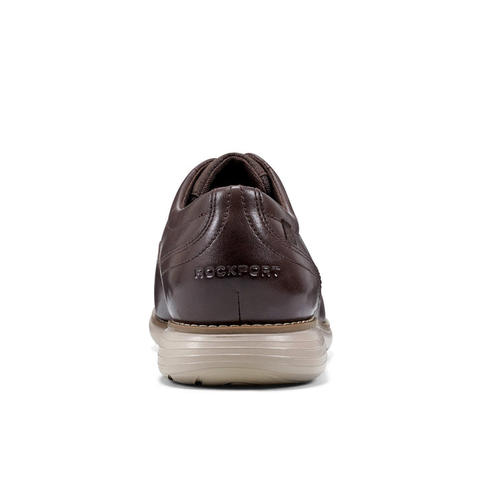 Rockport Garett Plain Toe shoes in brown leather with embossed logo, beige sole, back view showing heel design.