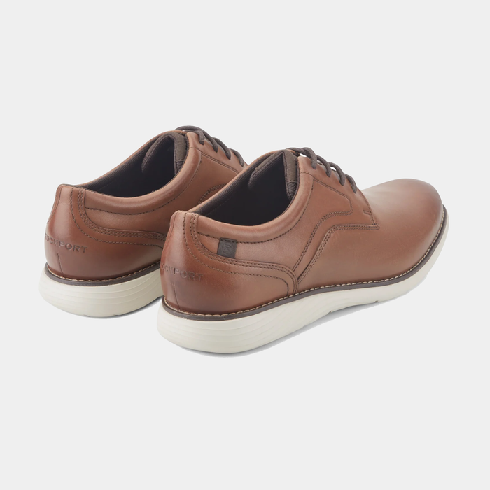 Rockport Garett Plain Toe shoes in tan leather with contrast stitching and white EVA outsoles, back angle view.