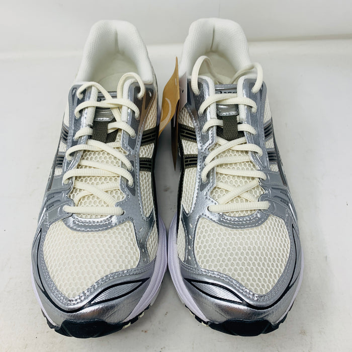 Brand new ASICS Gel-Kayano 14 Cream Black Metallic Plum sneakers rest elegantly on a pristine brown ASICS shoe box. With a mesh upper, metallic accents, and black details, these shoes stand out against a neutral backdrop.