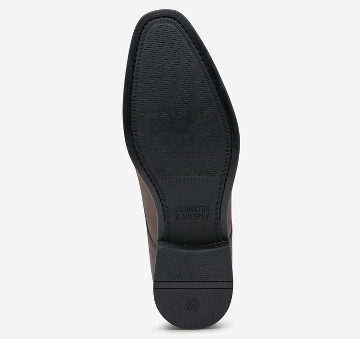 Johnston & Murphy Gibbons Cap Toe dress shoes sole view showing textured rubber outsole in black.