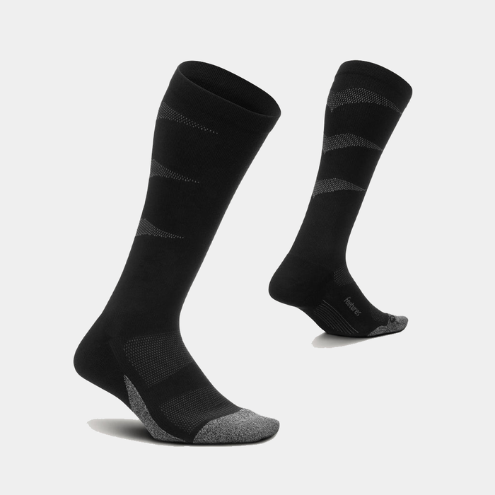 Feetures Graduated Compression Light Cushion Socks, black with gray toe and heel accents, featuring breathable mesh panels and knee-high design, angled view.