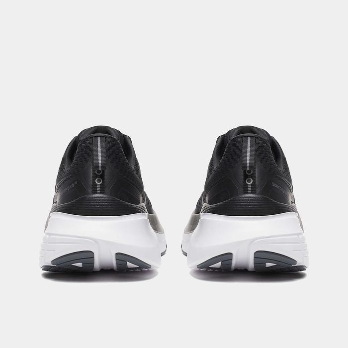 Saucony Guide 18 running shoes in black with white midsoles and reflective heel details, back view.