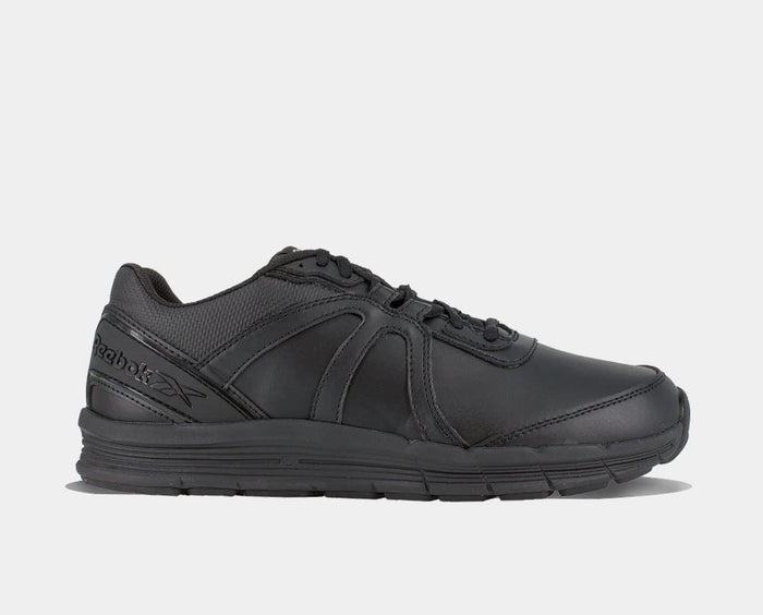 Reebok Work Guide Work shoes in all-black leather with mesh accents and slip-resistant outsole, side view.