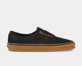 Vans Gum Authentic sneakers in black canvas with gold eyelets and gum rubber outsole, side view.