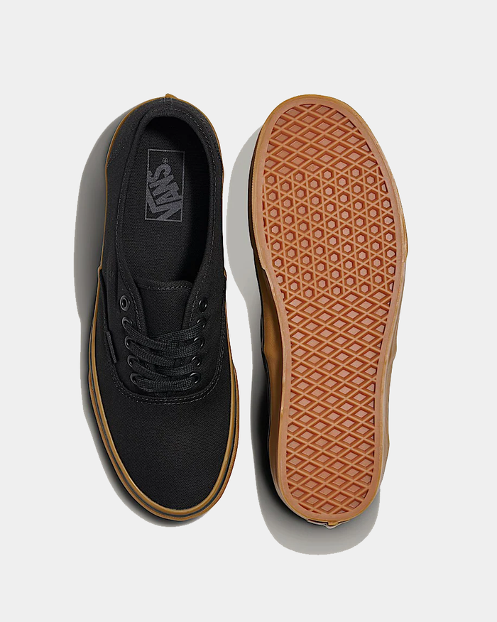 Vans Gum Authentic sneakers with black canvas upper, gum rubber sole, and classic waffle tread, top and sole views.
