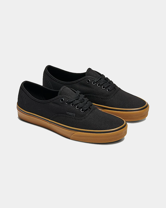 Vans Gum Authentic sneakers in black canvas with gum rubber outsole and lace-up closure, angled side view.