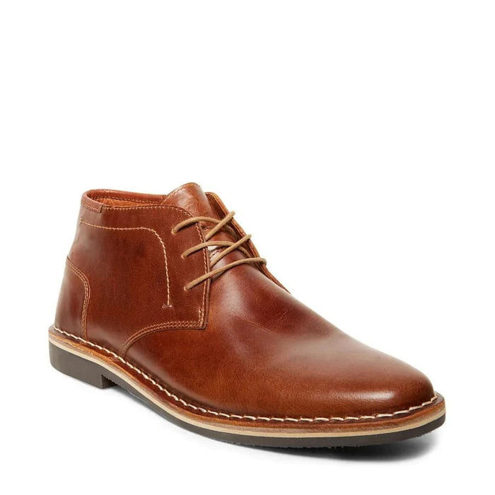 Steve Madden Harken chukka boots in brown leather with stitching details, three-eyelet laces, and contrast sole, front-side view.
