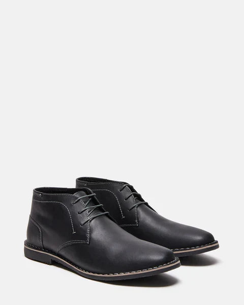 Steve Madden Harken boots in black leather with stitching accents and lace-up closure, angled front-side view.