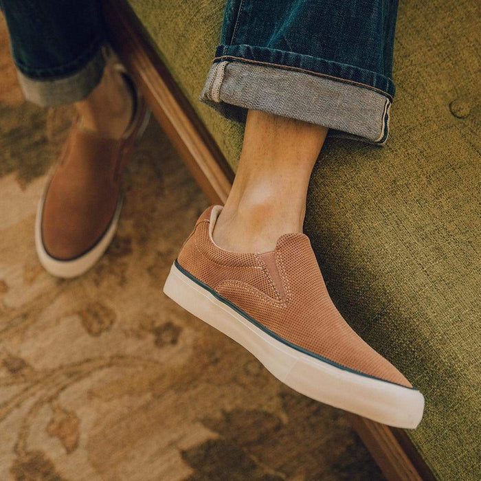 SeaVees Hawthorne Slip On shoes in light brown with a perforated suede upper and white sole, lifestyle view.