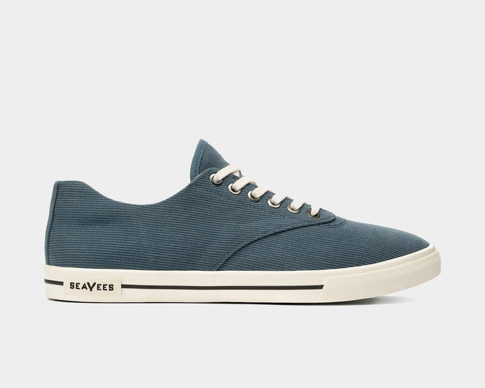 SeaVees Hermosa sneakers in slate blue with a textured canvas upper, white rubber sole with black stripe accents, side view.