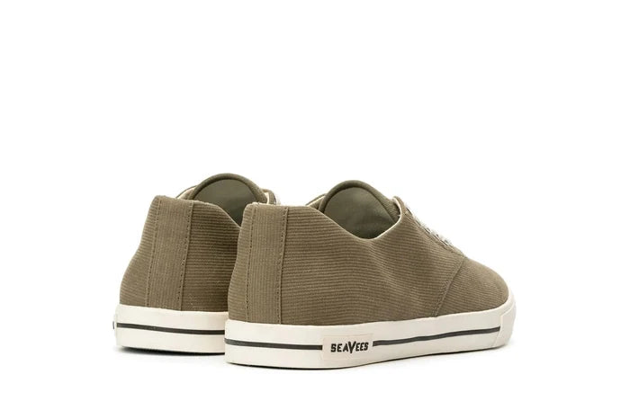 SeaVees Hermosa sneakers in olive green with canvas upper and white rubber outsole featuring black stripe detail, back view.