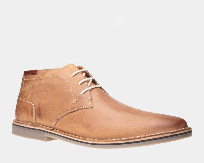 Steve Madden Heston chukka boots in tan leather with stitched detailing and lace-up closure, side view.