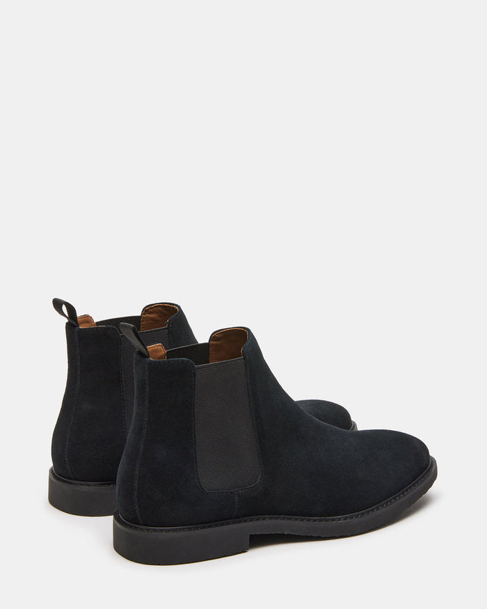 Steve Madden Highline Chelsea Boot in black suede with elastic side panels, pull tabs, and rounded toe, back angle view