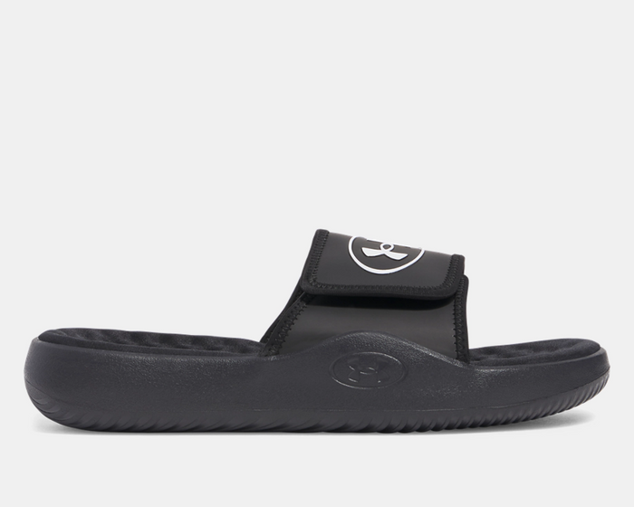Under Armour Ignite Pro 8 Slides in black with adjustable strap and cushioned footbed, side view.