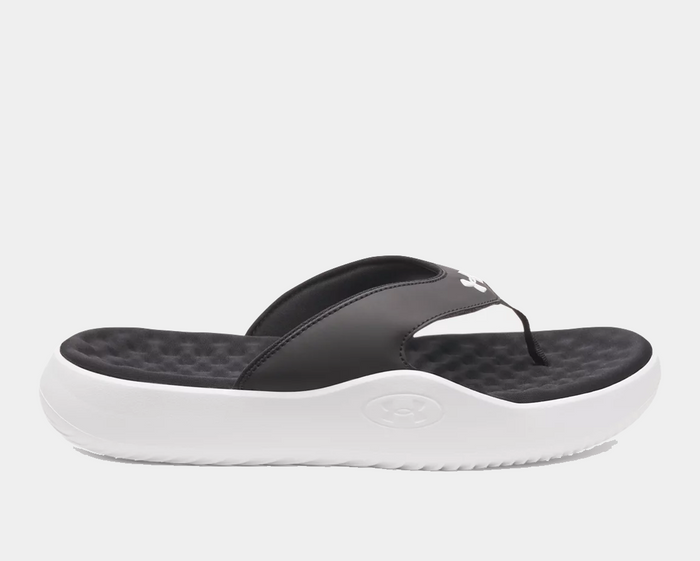Under Armour Ignite Pro 8 T sandals with black synthetic straps, cushioned black textured footbed, and white foam outsole, side view.
