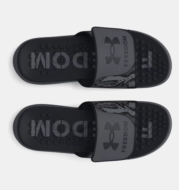 Under Armour Ignite Pro Freedom Slides in dark gray with textured footbed and branded strap, top view.