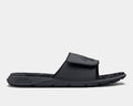 Under Armour Ignite Pro Graphic Strap Slides in black with perforated adjustable strap and cushioned footbed, side view.