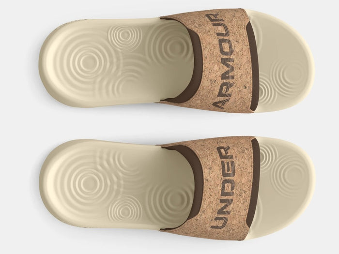 Under Armour Ignite Select Cork Slides in beige with cork-textured strap and cushioned footbed, top view.