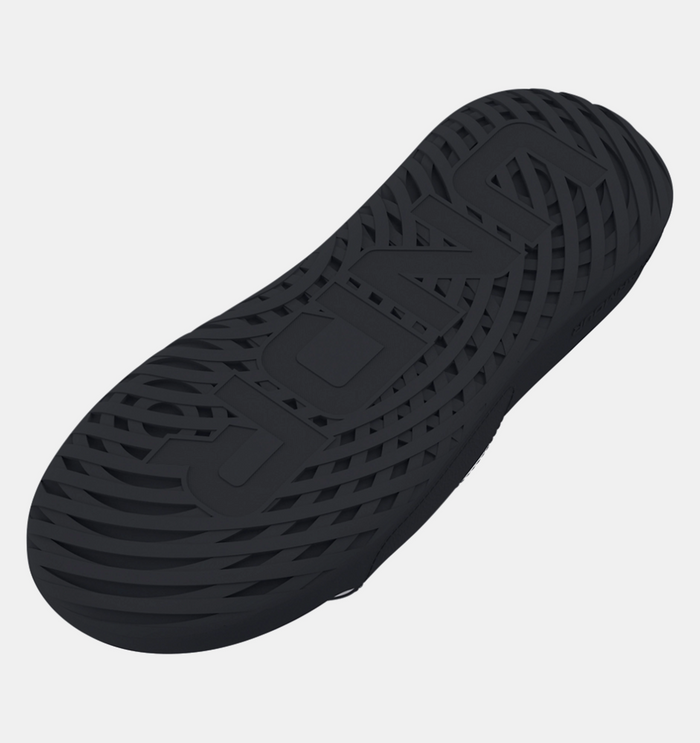 Under Armour Ignite Select sandal outsole in black showing textured rubber tread design for traction, sole/bottom view.