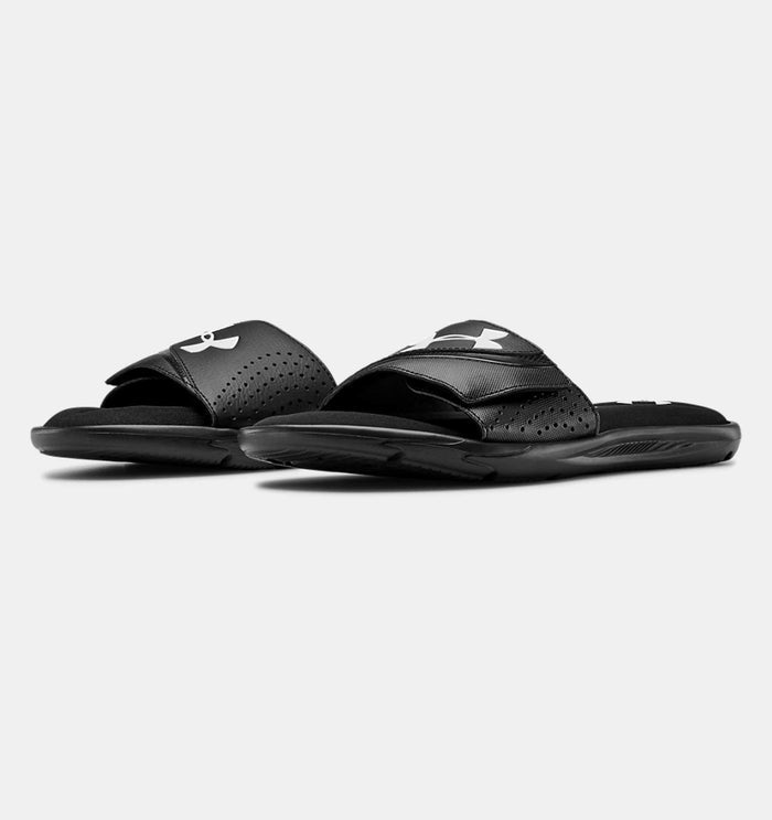 Under Armour Ignite VI SL black slides with adjustable synthetic straps, soft foam footbed, and textured outsoles, angled front view.