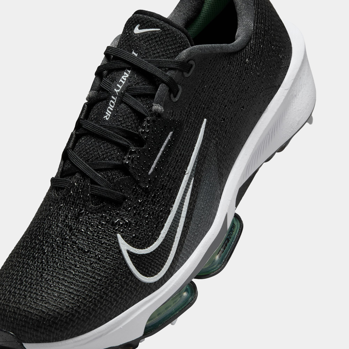 Nike Infinity Tour 2 golf shoes in black with a breathable mesh upper, white swoosh logo, and Zoom Air cushioning, angled close-up view.