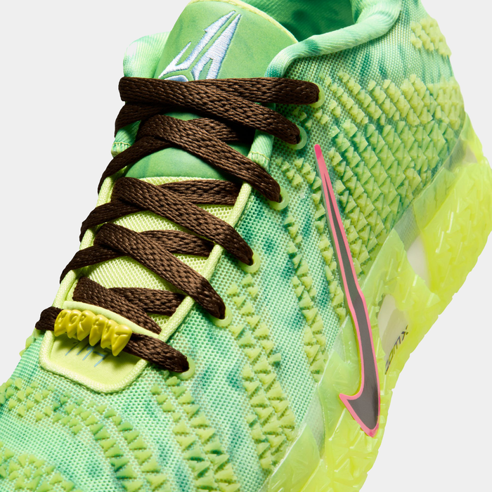 Nike Ja 3 "Halloween" basketball shoes close-up showing green mesh upper, brown laces, neon yellow midsole, and pink-accented Nike Swoosh.