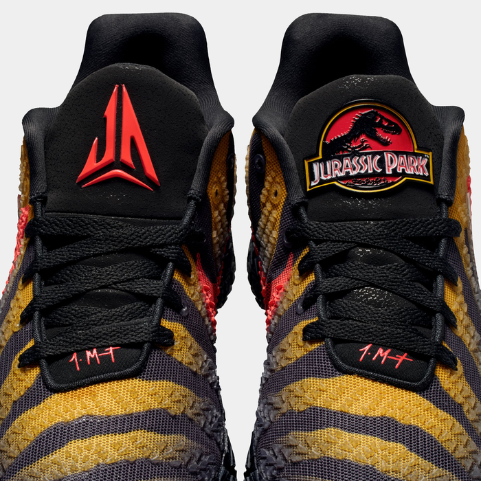 Nike Ja 3 x Jurassic Park "Raptor" basketball shoes with black tongues, vibrant yellow and orange patterns inspired by raptor design, top view showing branding details.