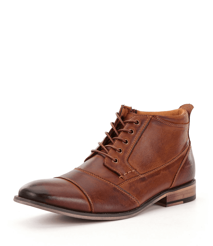 Steve Madden "Jabbar" boots in brown suede with cap-toe design, lace-up closure, and wooden heel, angled side view.