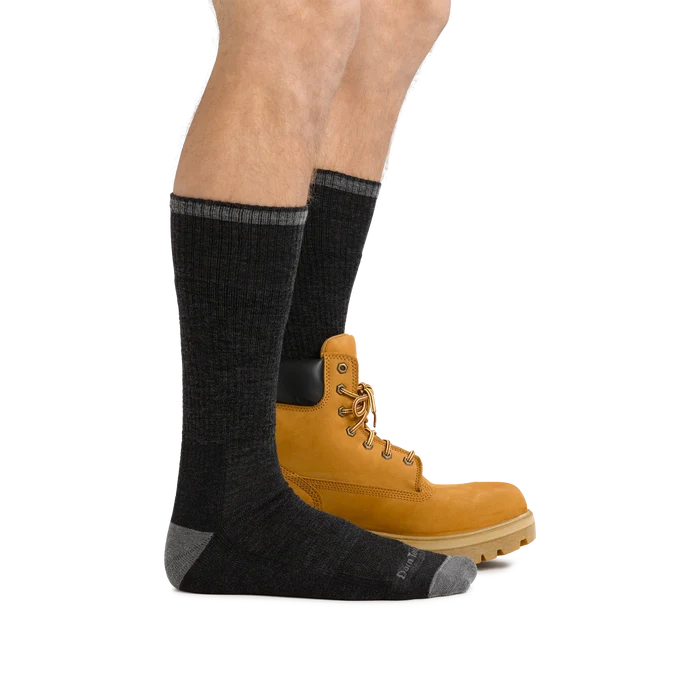 Darn Tough John Henry Boot Midweight Work Sock in dark gray with reinforced heel and toe, worn with work boots.