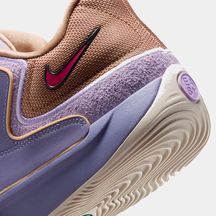 Nike KD 18 basketball shoes close-up showing textured mauve and light purple upper, pink Nike logo, and cream outsole.