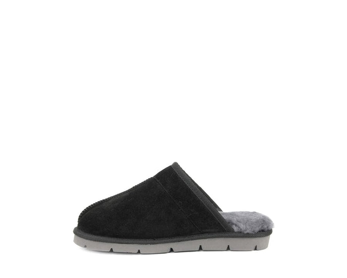 SuperLamb Khulan slippers in black suede with a gray plush interior lining and a durable gray sole, side view.