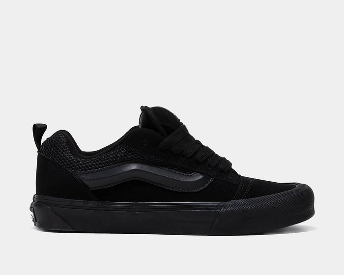 Vans Knu Skool Core sneakers in all-black with suede and mesh upper, signature side stripe, and chunky sole, side view.