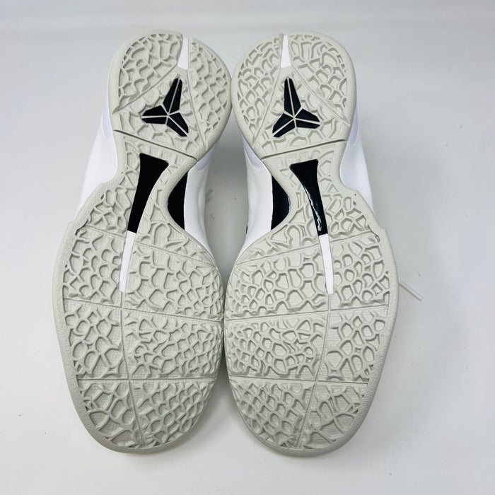 The fresh white Nike Kobe 6 Sail All-Star (GS) athletic shoe, showcasing a textured design and black swoosh logo, is presented on an orange box. Inside are plastic-wrapped accessories and extra laces for versatile style in 2024.