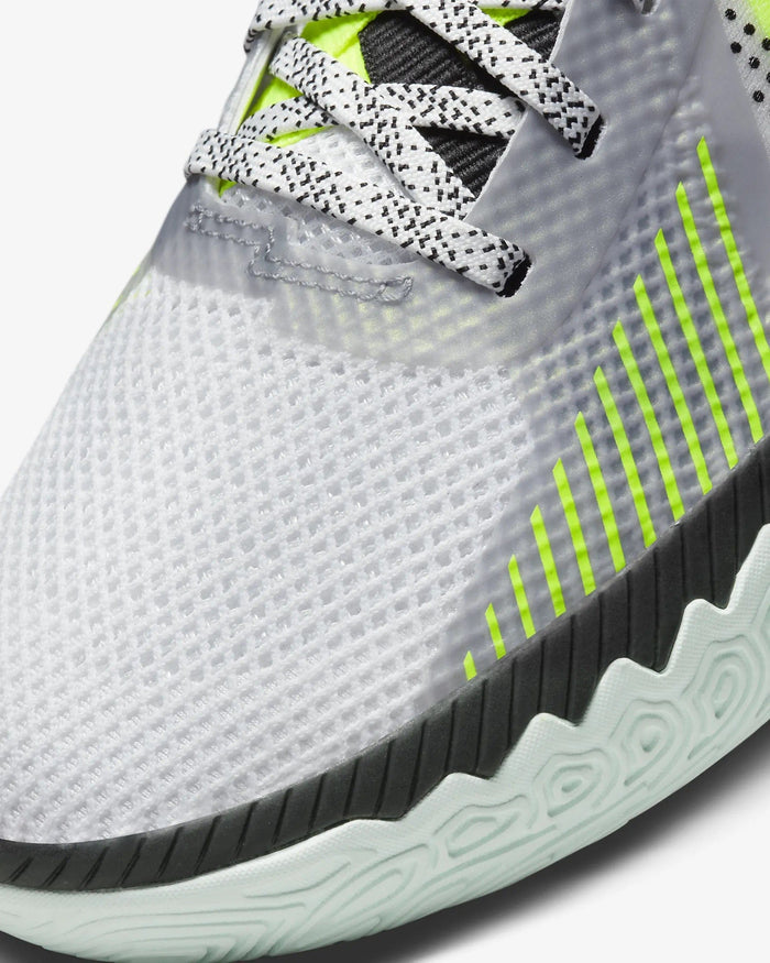 Nike Kyrie Flytrap V basketball shoes, close-up of the white mesh upper with neon green accents and black outsole detailing.