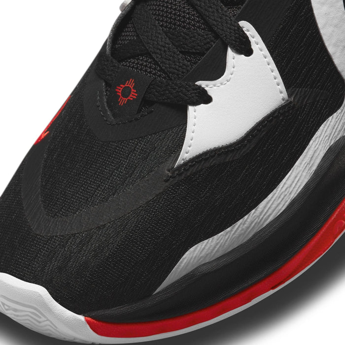 Nike Kyrie Low 5 basketball shoe in black, white, and red with mesh upper, embroidered detail, and textured midsole, close-up of toe box.