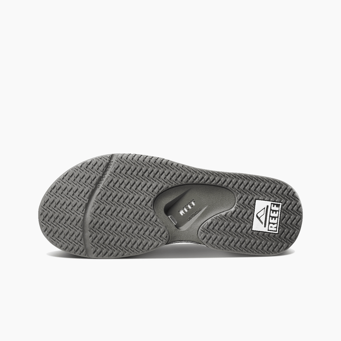 Reef Leather Fanning Flip Flops outsole showing textured tread pattern in gray with built-in bottle opener.