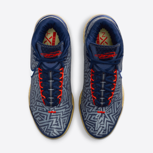 Nike LeBron NXXT Genisus basketball shoes with blue geometric-patterned upper, red laces, and beige outsole, top view.
