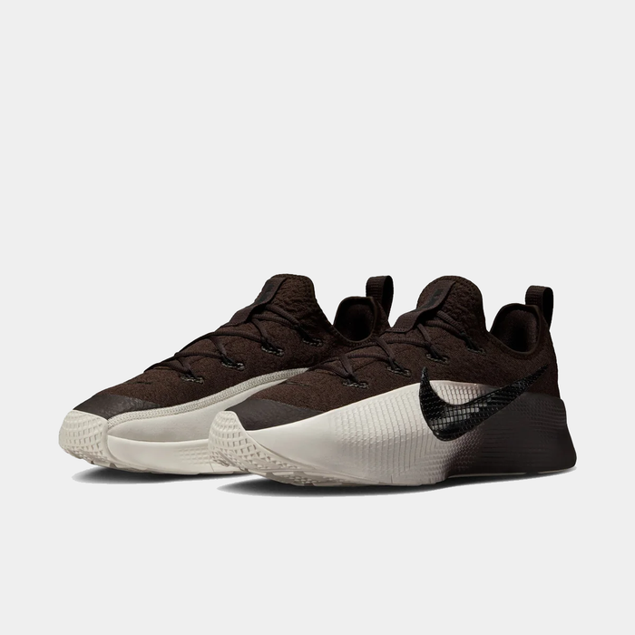Pair of brown and white sneakers on a light gray background