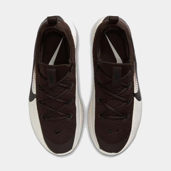 Pair of brown sneakers with white soles on a light gray background