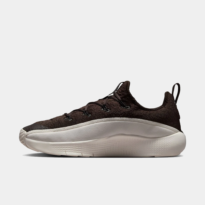 Brown sneaker with white sole on a light gray background